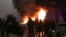Горящий полицейский автомобиль во время январских протестов из-за повышения цен на газ в Алматы 5 января 2022 года
