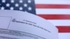 USA-U.S. flag and U.S. H-1B Visa application form are seen in this illustration taken September 26, 2025.